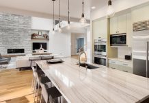 Urban Kitchen with Granite Tops, Exposed Bulb Lights and Island Portal