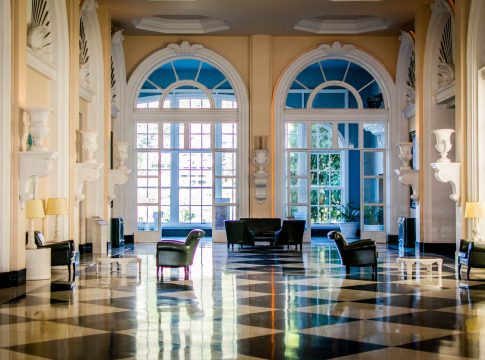 Luxe Hallway with Chess Table Flooring and Large Rounded Windows