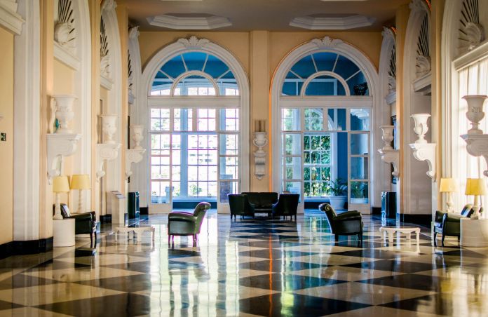 Luxe Hallway with Chess Table Flooring and Large Rounded Windows